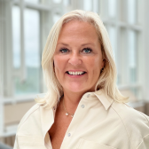 Photo of a smiling Catarina Sjömark in a beige shirt